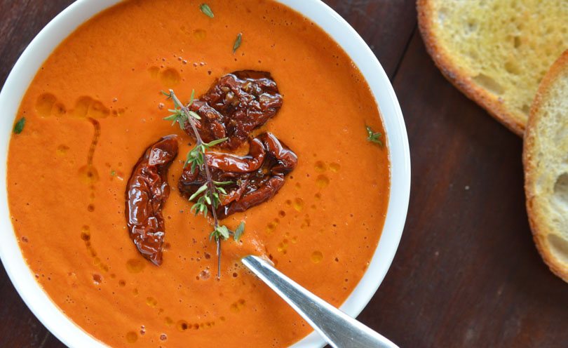 Vitamix tomato soup with sun-dried tomatoes and thyme as garnish.