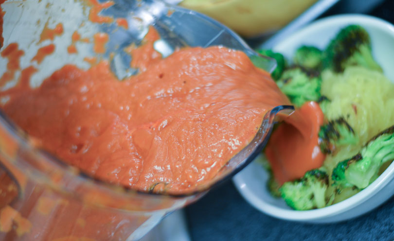 pouring vodka sauce on spaghetti squash spaghetti