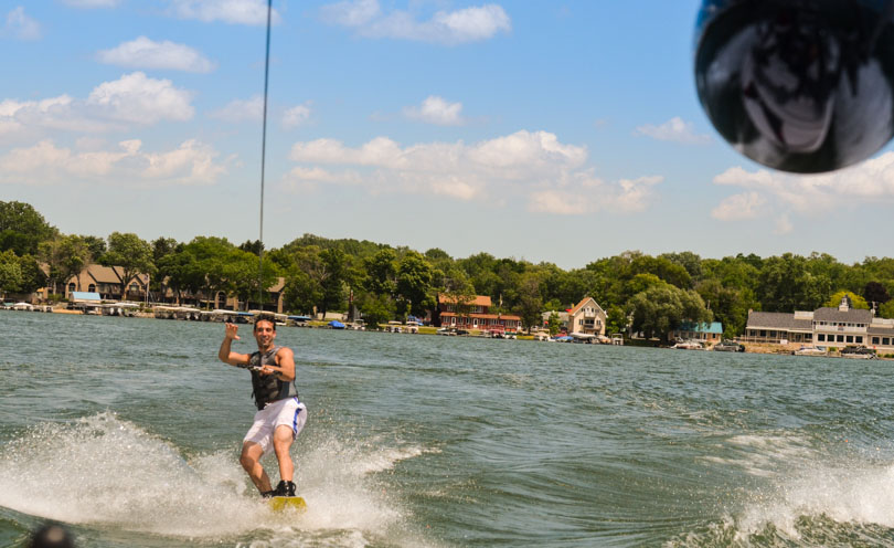 Lenny Gale acknowledging high five-ables with a high five while wakeboarding.