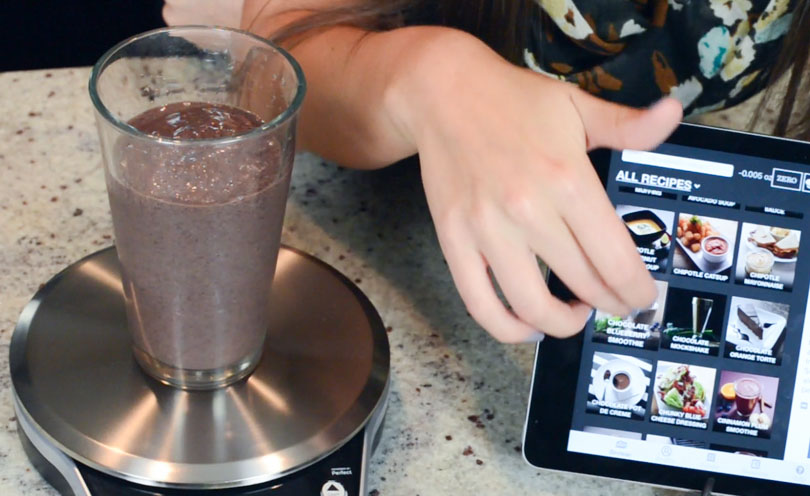 Chocolate blueberry smoothie being measured by a Perfect Blend Smart Scale.