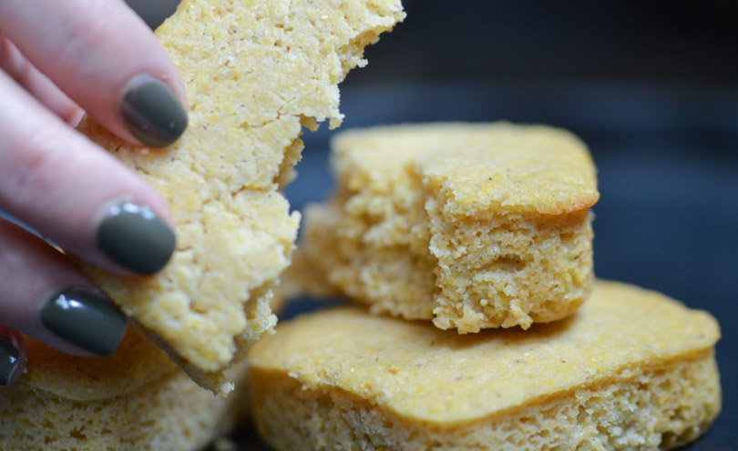 Vegan corn bread stacked and held with Shalva's hands.