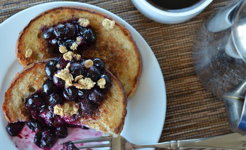 Vegan french toast served with blueberries and granola on top.