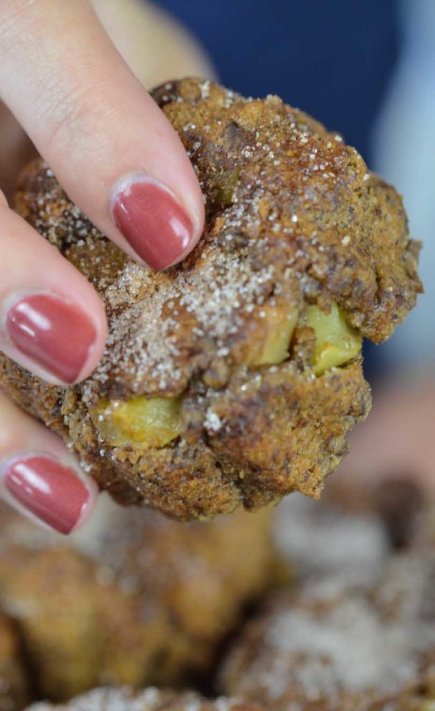 Shalva's hand grabbing a mini apple cinnamon cake.