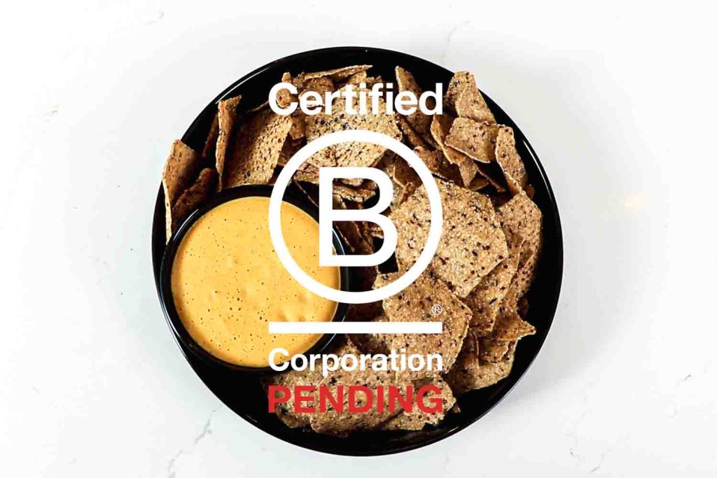 Blending For Good's pending Certified B-Corp logo over a bowl of chips and queso.